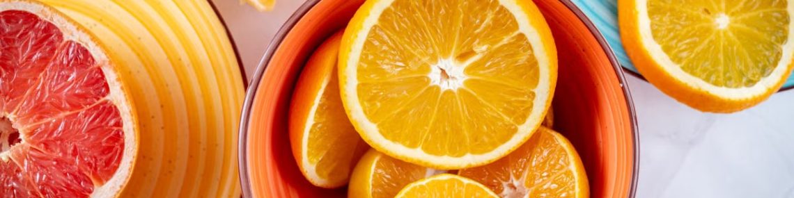 Citrus slices creatively arranged in ceramic bowls, showcasing a vivid and fresh presentation of grapefruits and oranges.